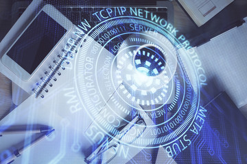Double exposure of technology theme drawing over work table desktop. Top view. Global data analysis concept.