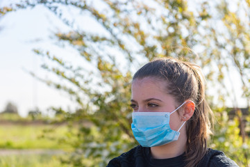 Coronavirus Covid-19 is spreading throughout Europe and Italy. Young girl before playing outdoors,...