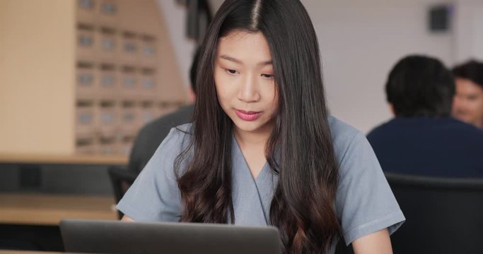 Asian woman working on laptop computer try to thinking solving problem at office, serious woman search for inspiration make decision feel lack of ideas.

