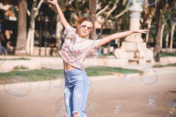 Barcelona, Spain, girl playing and having fun with a soap bubble