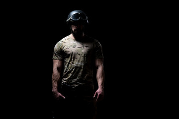Fototapeta na wymiar Warrior With Gun on a Black Background