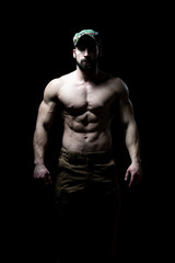 Fototapeta na wymiar Portrait of a Bodybuilder Isolate on Black Blackground
