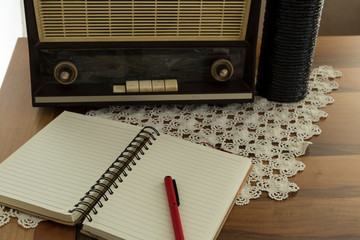 The old vintage radio on the wooden table.