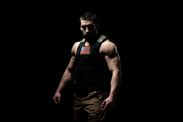 Fototapeta na wymiar Bodybuilder Soldier With Bulletproof Vest on Black Background