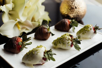 Strawberry dessert with a bouquet of yellow callas.