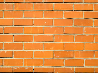 Fragment of a red brick wall, background.