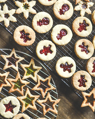 A close-up of Christmas biscuits and cookies with jam, flat lay