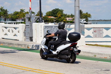 Motorcycle waiting for a causeway bridge to open for vehicular traffic.