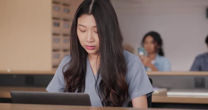 Asian woman working on laptop computer try to thinking solving problem at office, serious woman search for inspiration make decision feel lack of ideas.
