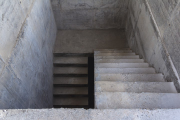 Concrete staircase to the basement of the building. Stairs down