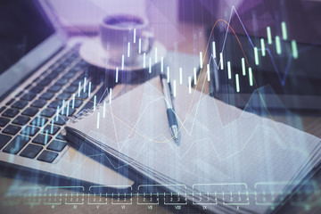 Double exposure of forex chart drawing and desktop with coffee and items on table background. Concept of financial market trading