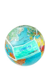 Surgical mask with Covid-19 written on planet Earth white background, Concept of global spread of Covid-19. Coronavirus outbreak virus quarantine , concept of quarantine 