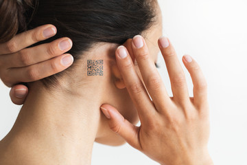 Woman with QR code behind ear. Future technology of chipization people for observation in...