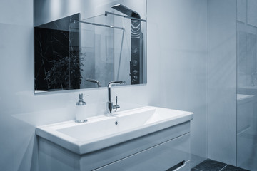 Luxury modern style faucet on a white sink in a beautiful bathroom