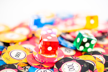 Poker chips and dice on a white background