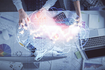 Double exposure of man and woman working together and human brain hologram drawing. Brainstorm concept. Computer background. Top View.