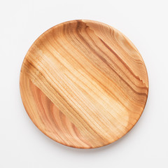 Wooden plate on white background, close up
