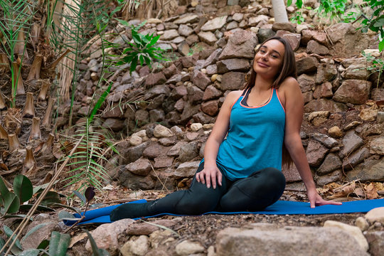 Young woman practicing yoga in the parck