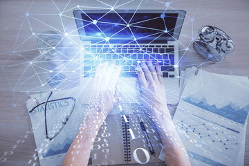 Double exposure of woman hands working on computer and data theme hologram drawing. Top View. Technology concept.