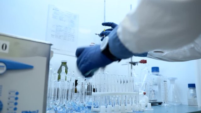 chemist hands using pipette and vial. dropping sample into test tube. Laboratory equipment spbas for research. scientist working. doctor fills vials. concept dna test