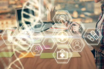 Double exposure of woman hands typing on computer and DNA hologram drawing. Medical education...