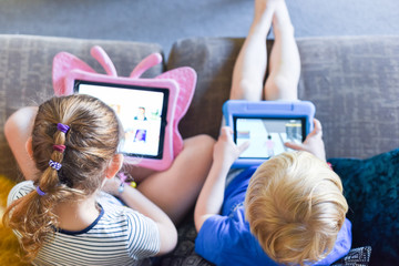 Children using their tablet device to play computer games and use educational apps