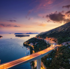 Bridge along the sea shore during sunset. Aerial landscape. View from drone. Evening landscape with...