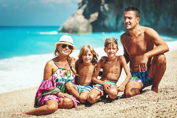 Happy Family Of Four On Beach