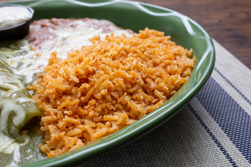 A closeup view of a side of Mexican rice, in a restaurant or kitchen setting.