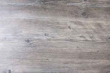 A modern rustic wood background, featuring small knots and slanted scratch designs.
