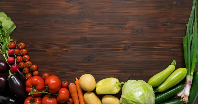 Moving vegetables on kitchen table, harvest background