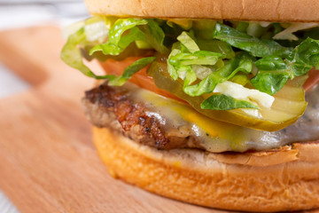 A closeup view of a turkey burger, in a restaurant or kitchen setting.