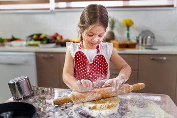 Girl making gingerbread cookies