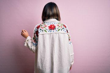 Young beautiful woman wearing fashion urban clothes, model wearing casual street style standing over pink background