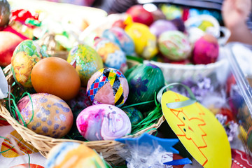 Fototapeta na wymiar Colored Easter eggs in the basket, colored by children. Easter concept