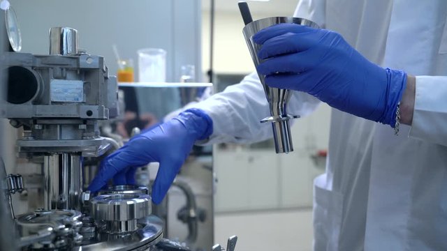 pharmaceutical plant factory worker making inspection checks spbas adjusts machine quality control of equipment that produces drugs, pills. concept pharma, automated, medical