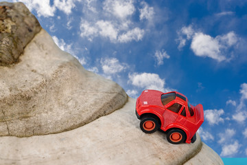 Obraz na płótnie Canvas Toy car on mountain Blue sky