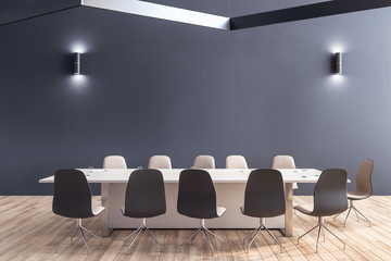 Modern conference room interior with blank gray wall with lights
