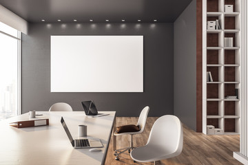 Clean meeting room interior with blank poster on wall.