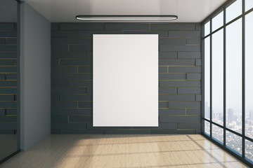 Brick gallery interior with blank poster on gray wall