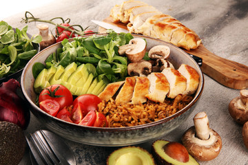 Healthy salad bowl with quinoa, tomatoes, chicken, avocado and mixed greens, lettuce. Food and health bowl