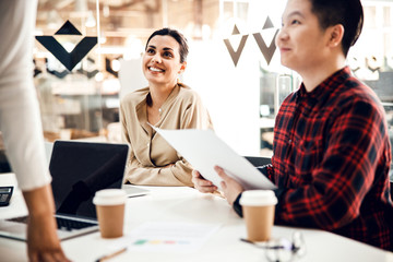 Cheerful business colleagues working together in office