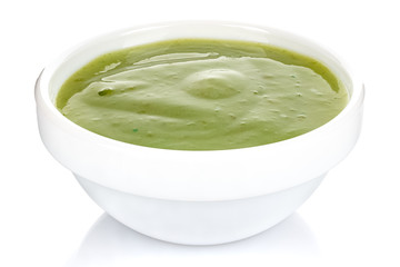 Green chili sauce with lime in a small white ceramic round bowl isolated on white background