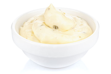 Tartar sauce with onions and pickled cucumbers in a small white ceramic round bowl isolated on white background