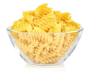 Dried italian pasta spiral Fusilli in a transparent glass round bowl isolated on white background