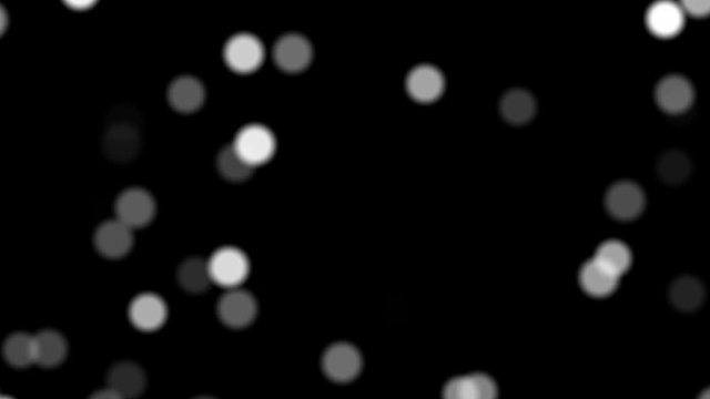 White particles in the form of circles with different transparency randomly moving on a black background, computer moving graphics mini video clip
