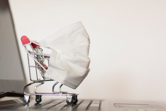 Shopping Cart With Protective Face Mask On Laptop Computer