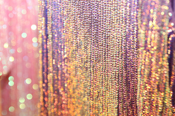 Rainbow blurred background, gold, pink and multicolored sequins on the fabric