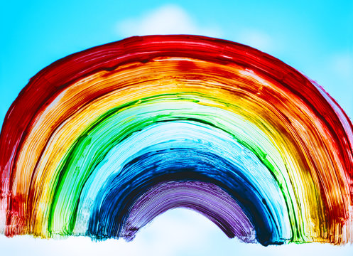 Close-up photo of painting rainbow on window