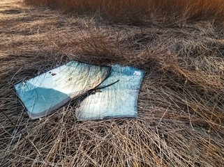 Broken car windshields in an illegal dumping ground
